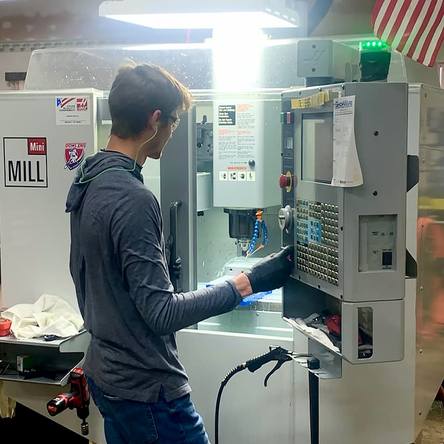 An engineer testing a Trika fishing rod in an industrial sized machine